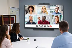 Large display hanging on a wall in the front of a conference room