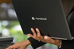Sharp Dynabook laptop being held in someones hand