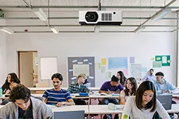 Ceiling projector in a classroom filled with students